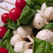 caprese salad skewers piled on a plate
