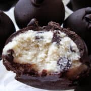 a cookie dough truffle with a bite taken out of it to show the inside