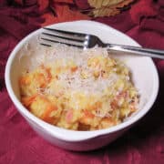 a white bowl of saffron risotto with butternut squash on a fall table
