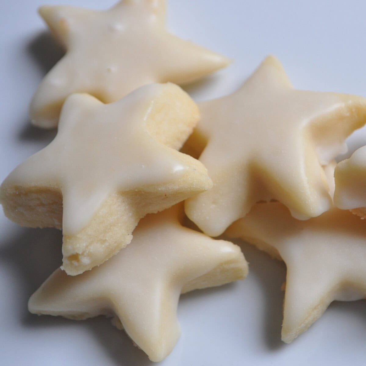 iced vanilla shortbread cookies on a white plate
