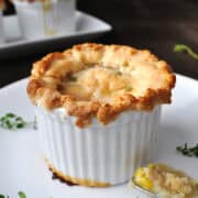 Costco Chicken Pot Pie in ramekin with spoon of filling next to it on the plate