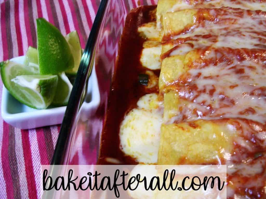 Chicken Enchiladas with Red Chile Sauce with limes in a dish