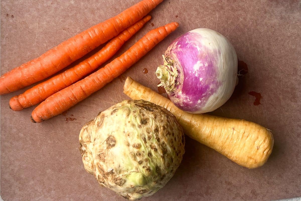 4 root vegetables on a cutting board