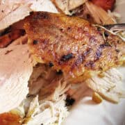 herb roasted turkey breast sliced on a turkey platter