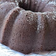 rich chocolate Bundt cake on a clear platter