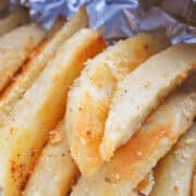 Parmesan Potatoes piled up on top of aluminum foil