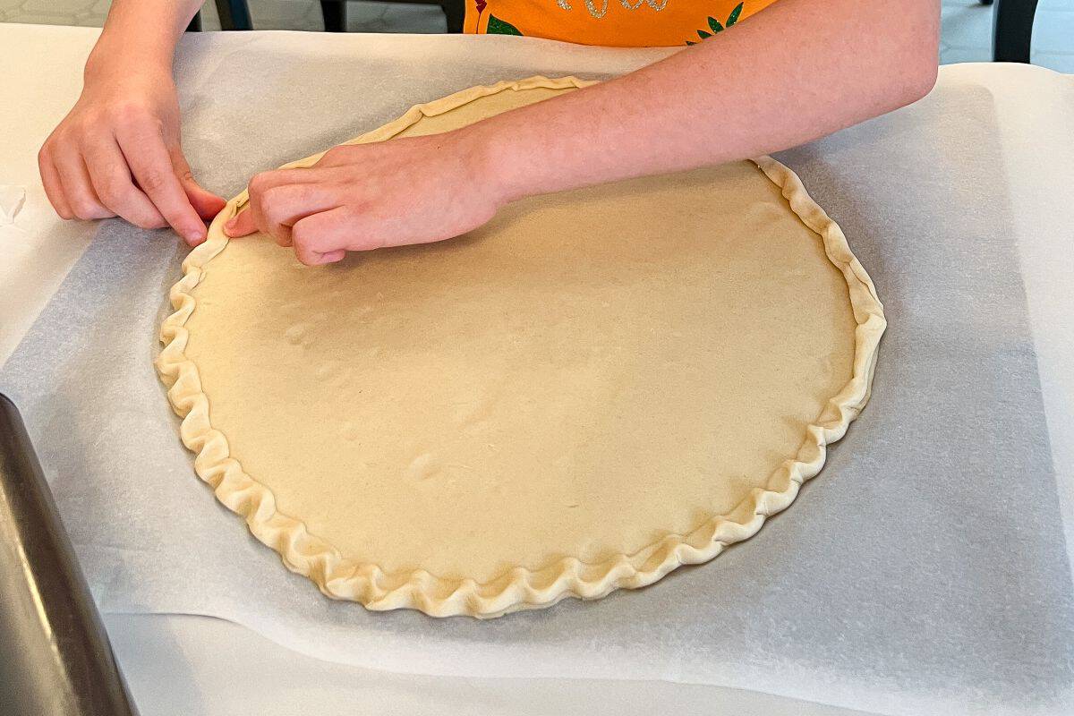 a double crust pie dough pressed out into the shape of a pizza