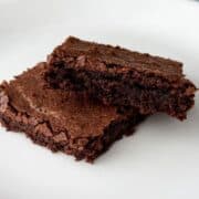 two dairy free soy free brownies stacked on a white plate