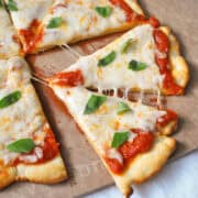 quick homemade no yeast pizza dough pizza on a cutting board cut into slices
