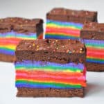 a plate with 4 rainbow brownie ice cream sandwiches
