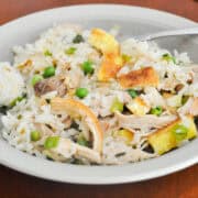 a bowl of Chicken fried rice with a fork in it