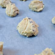 balls of egg free cookie dough on a parchment lined cookie sheet
