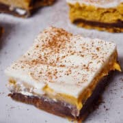 Pumpkin Chocolate Cheesecake Bars on a white plate