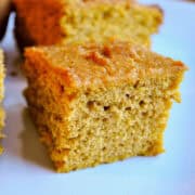 square pieces of pumpkin cornbread on a white plate
