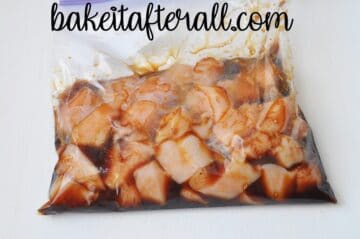 a bag of chicken breast pieces marinating in honey soy sauce