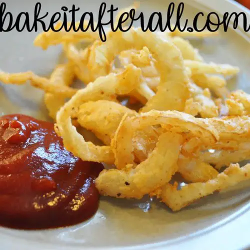 onion strings on a plate with ketchup