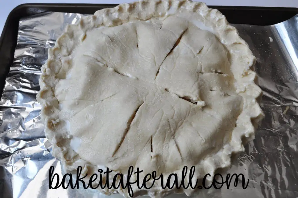 unbaked pie on a foil lined baking sheet