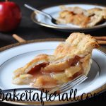 classic apple pie on a plate with a fork