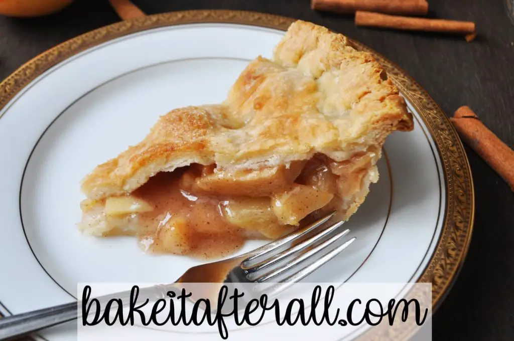 classic apple pie on a plate with a fork