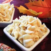 two dishes of honey butter on a fall table