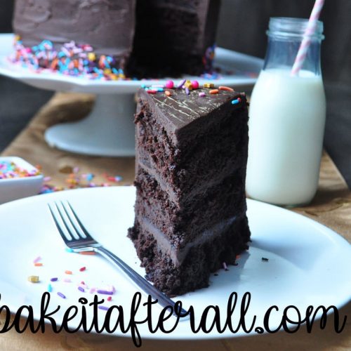 chocolate layer cake on a plate with a fork