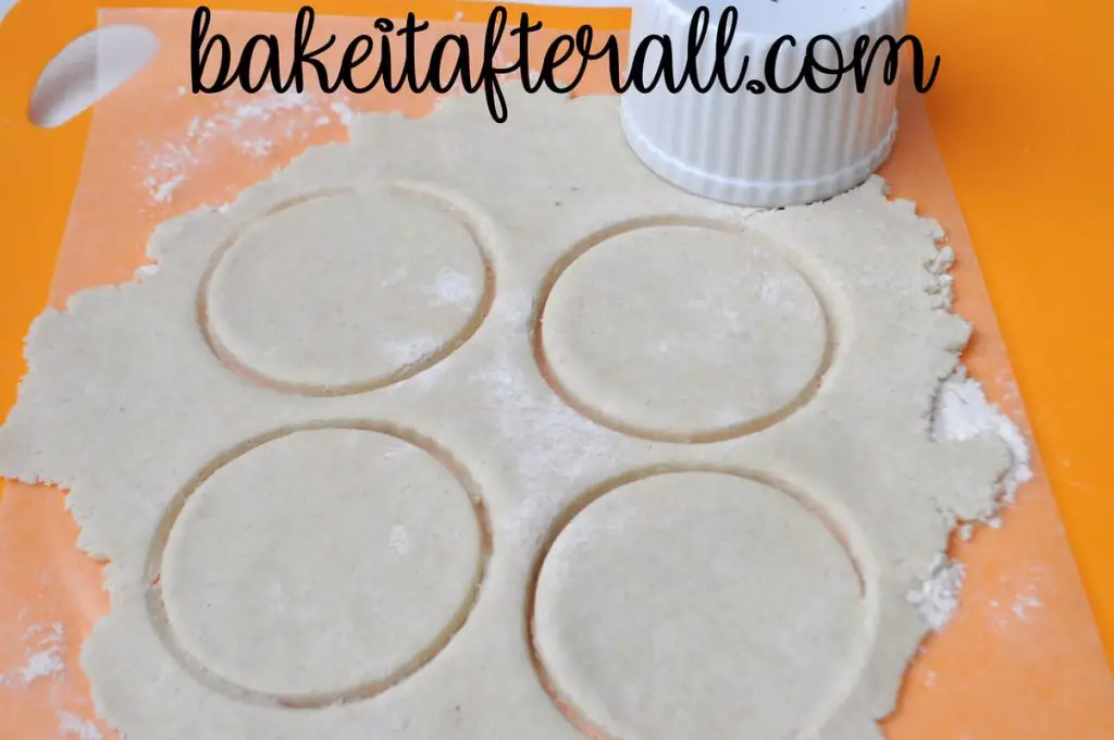 dough rolled on cutting mat cut into circles using ramekin