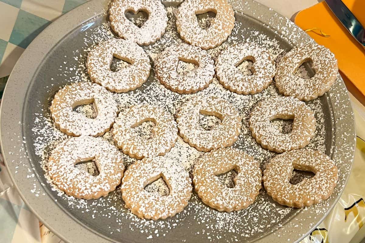 the top Linzer cookies sprinkled with powdered sugar