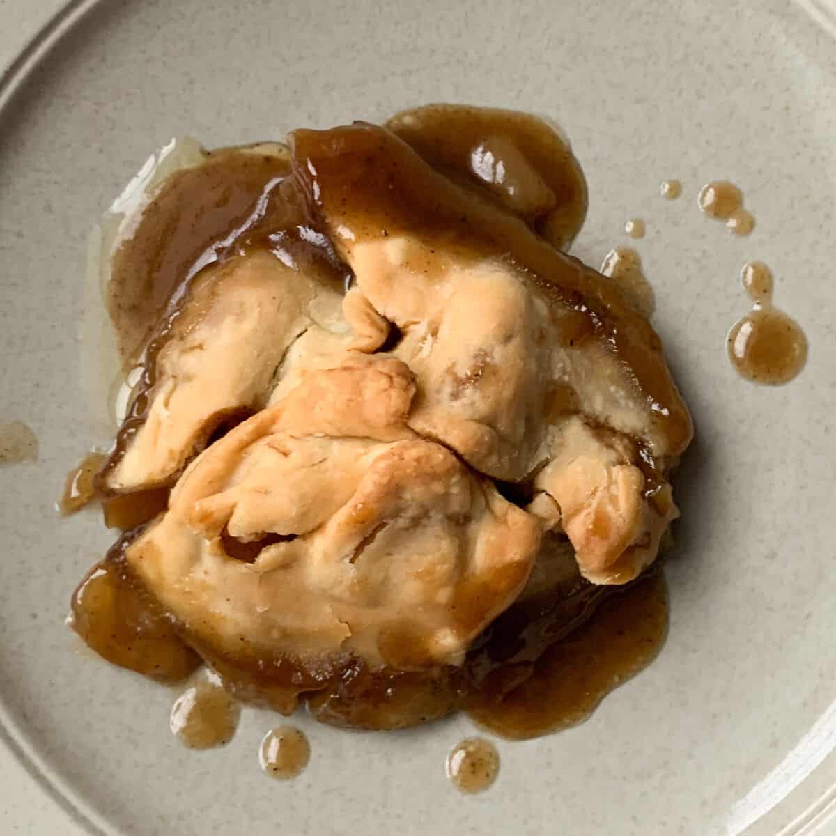 an apple dumpling on a plate