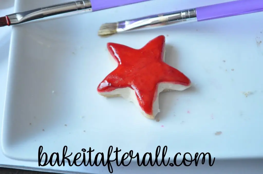 star cookie painted with red food coloring paint for the Painted Rainbow Cookies