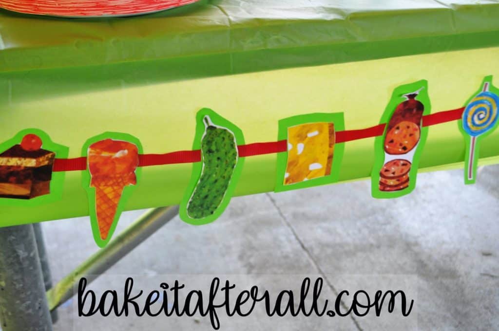 cut outs of the food the caterpillar eats as a banner