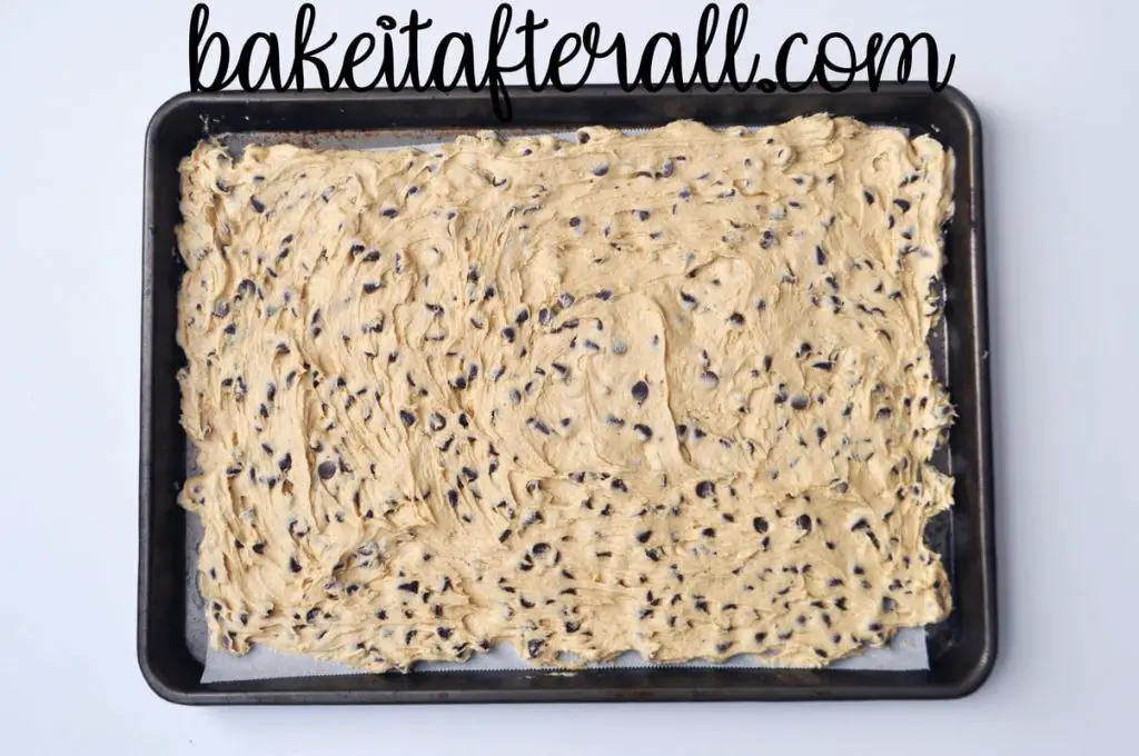 chocolate chip cookie dough spread into a sheet pan
