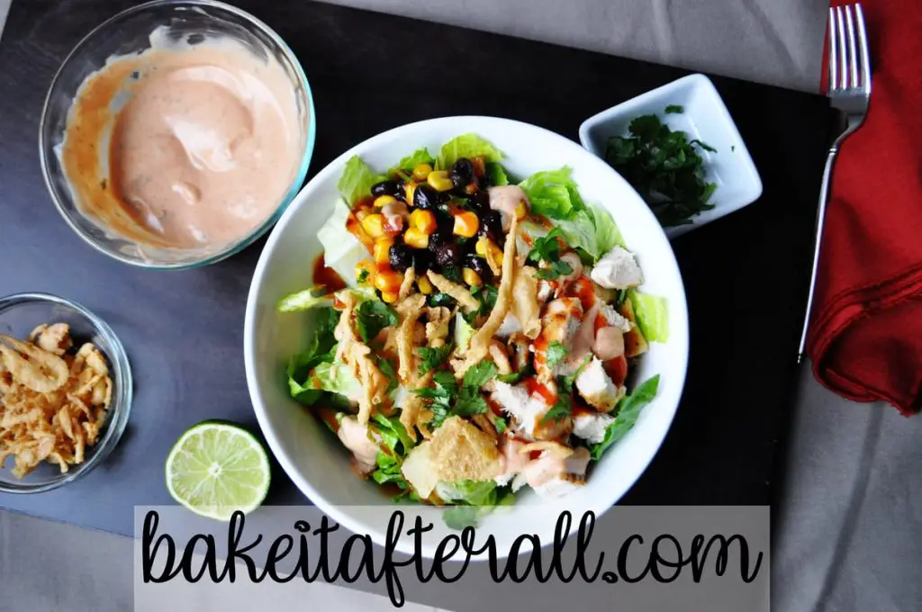 Panera BBQ Chicken Salad with Panera BBQ Ranch Dressing in a small bowl to the side