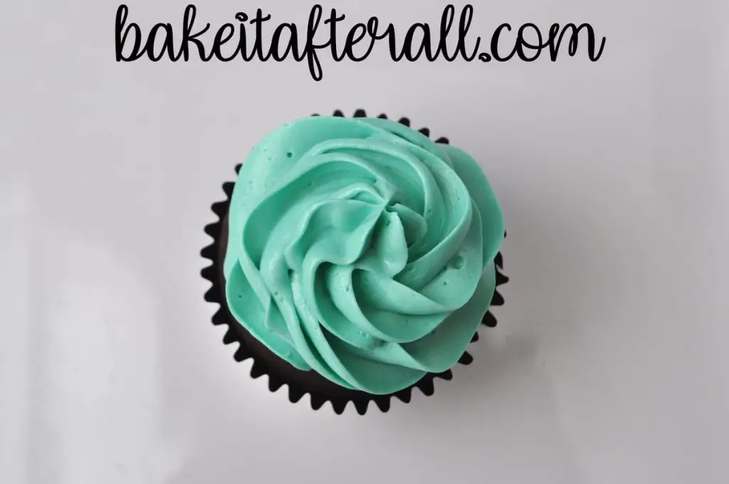 up close of single cupcake with blue buttercream piped on top