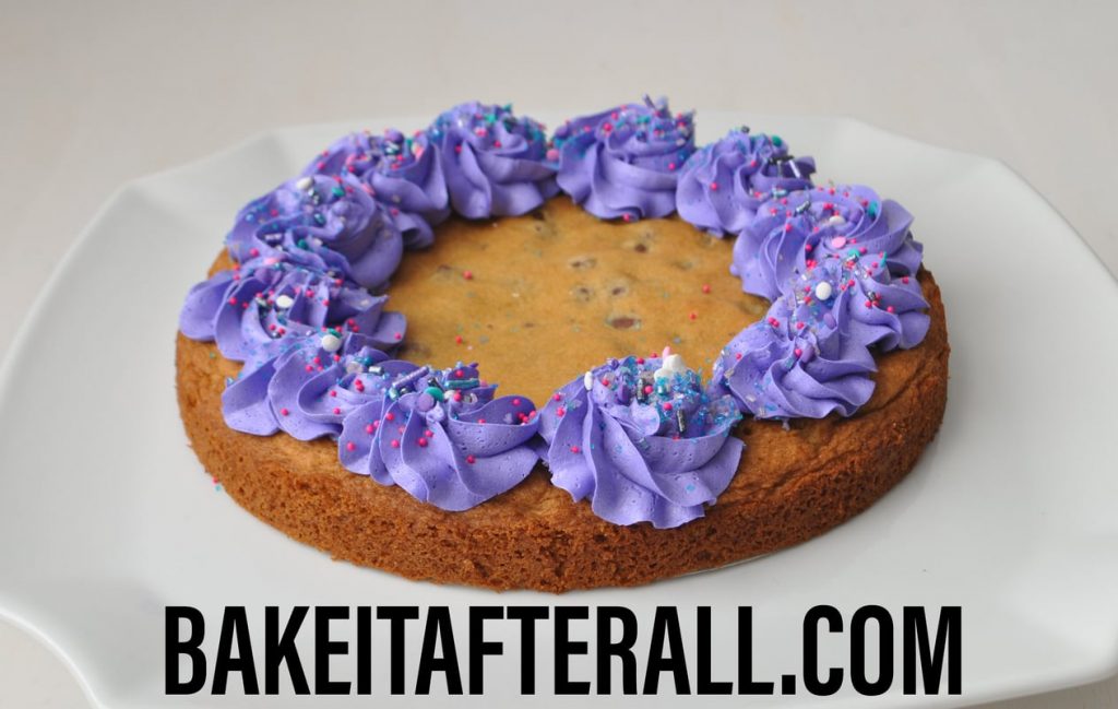 Chocolate Chip Cookie Cake with purple buttercream border and sprinkles