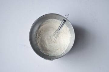dry ingredients in bowl with small wire whisk
