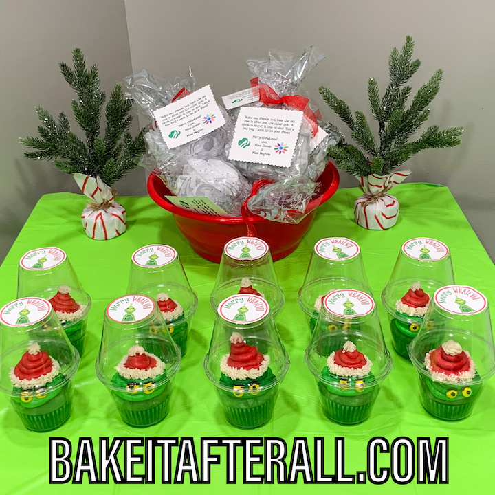 Grinch cupcake favors set on a table