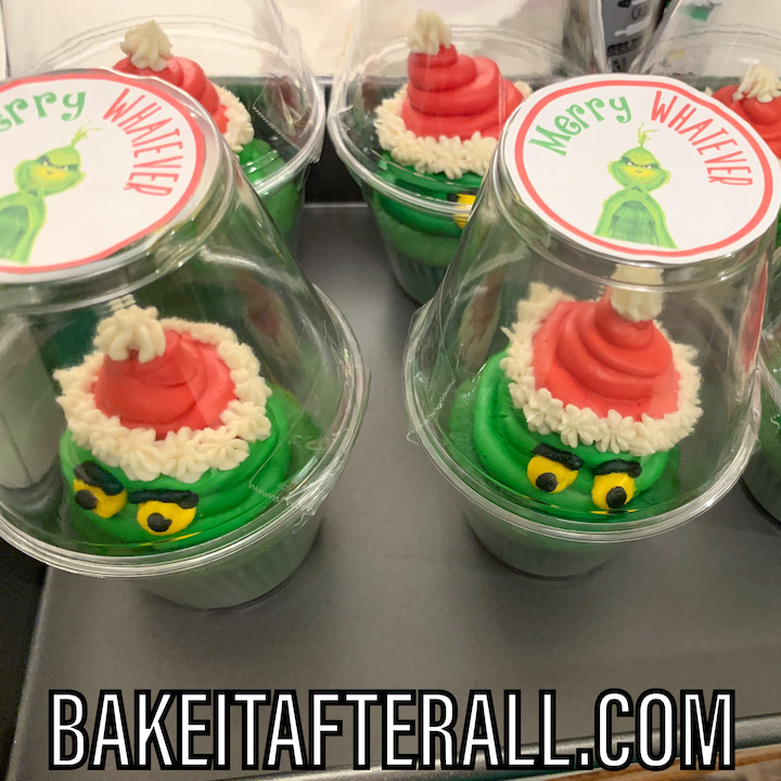 Grinch cupcakes packaged as favors