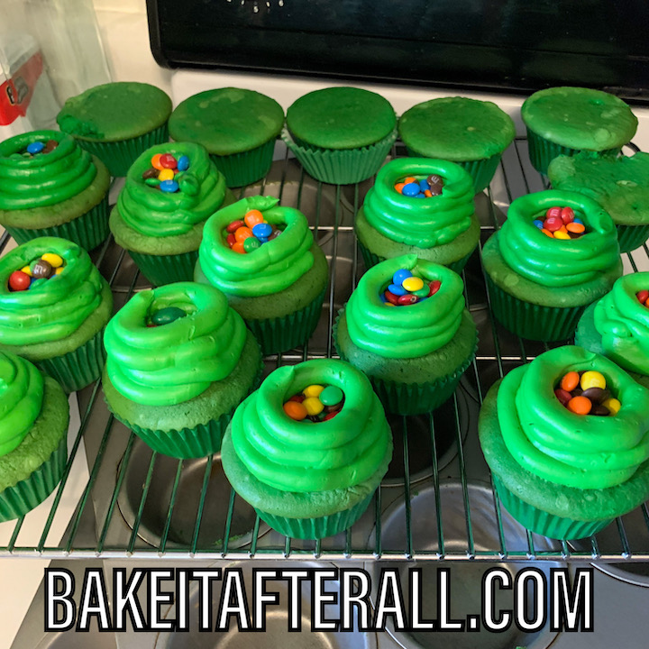 green frosted cupcakes filled with M&Ms