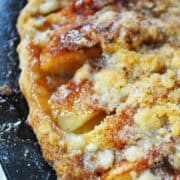 Apple Crumble Pizza Pie on a black pizza pan