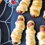 Halloween Crescent Mummy Dogs on a black platter