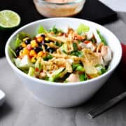 Panera BBQ Chicken Salad with Panera BBQ Ranch Dressing in a small bowl to the side