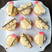 pencil and ruler wafer cookie cupcakes on a white cake plate