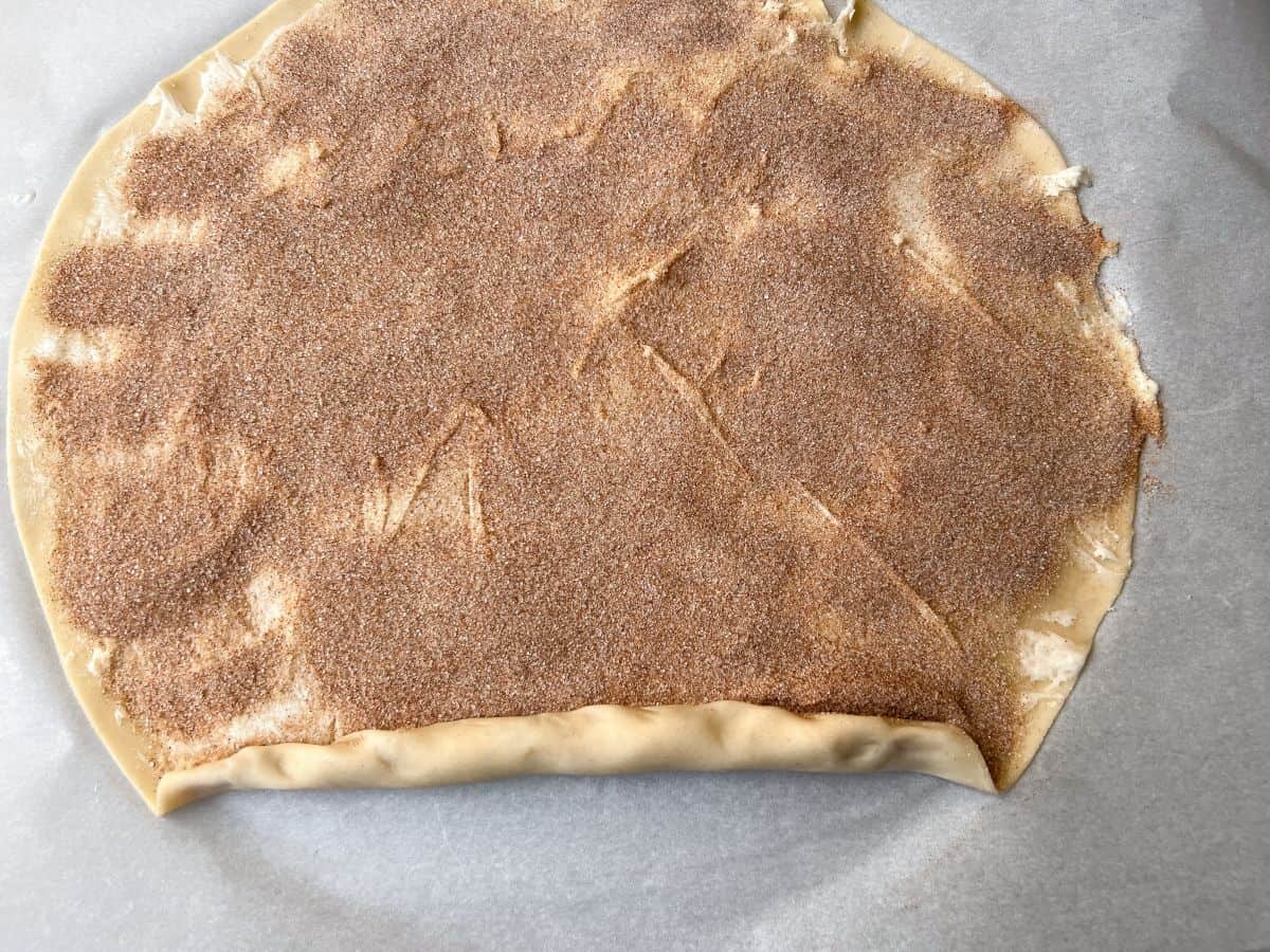 cinnamon sugar pie dough being rolled up