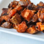 savory roasted sweet potatoes on a white plate