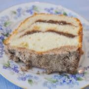 a slice of Sour Cream Coffee Cake with Brown Sugar Streusel on a blue and purple flowered China plate