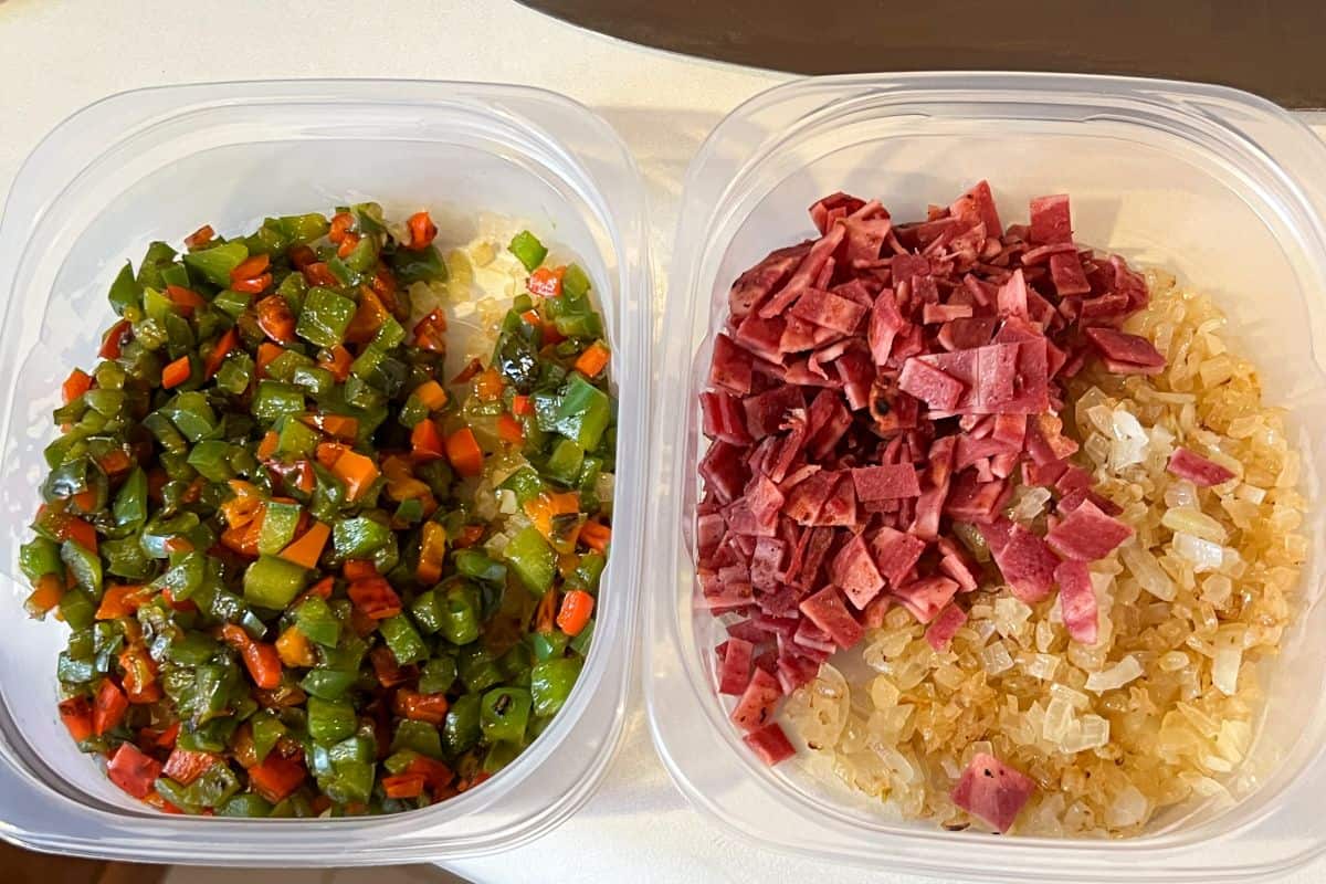 two plastic containers with sauteed peppers, onions and turkey bacon