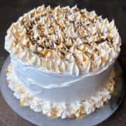 a Caramel Mocha Ice Cream Cake decorated with gold dust, caramel and chocolate syrup