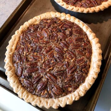 a pecan pie on a baking sheet on top of a stove