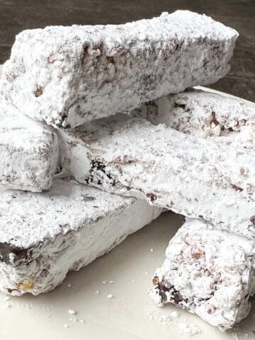 a plate with a pile of Nut Free Old Fashioned Date Bars stacked on top