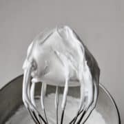 Snow Peak Frosting sticking up on the whisk attachment of a stand mixer